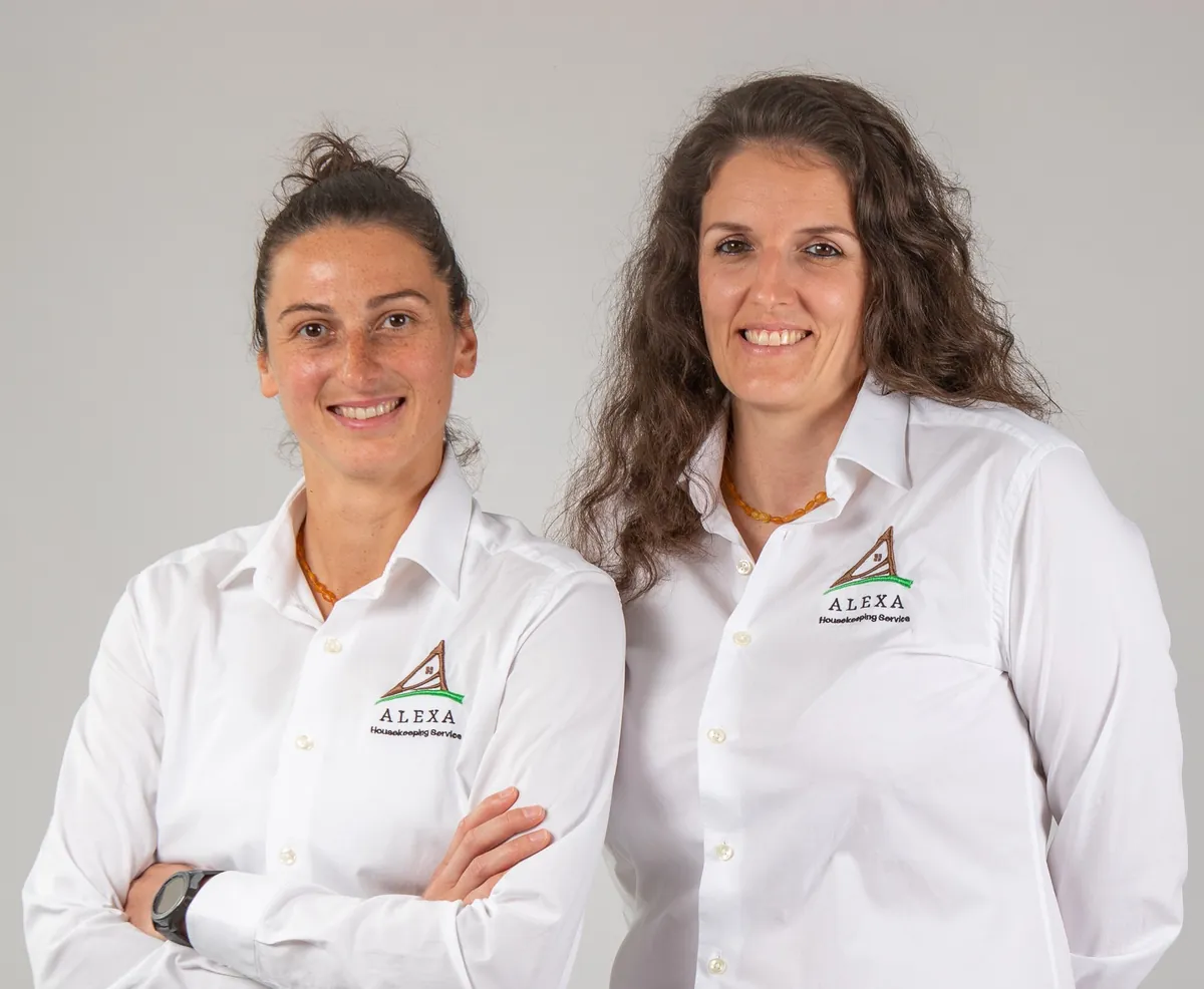 Alex and Didi of Alexa Housekeeping Service in white shirts with the embroidered company logo